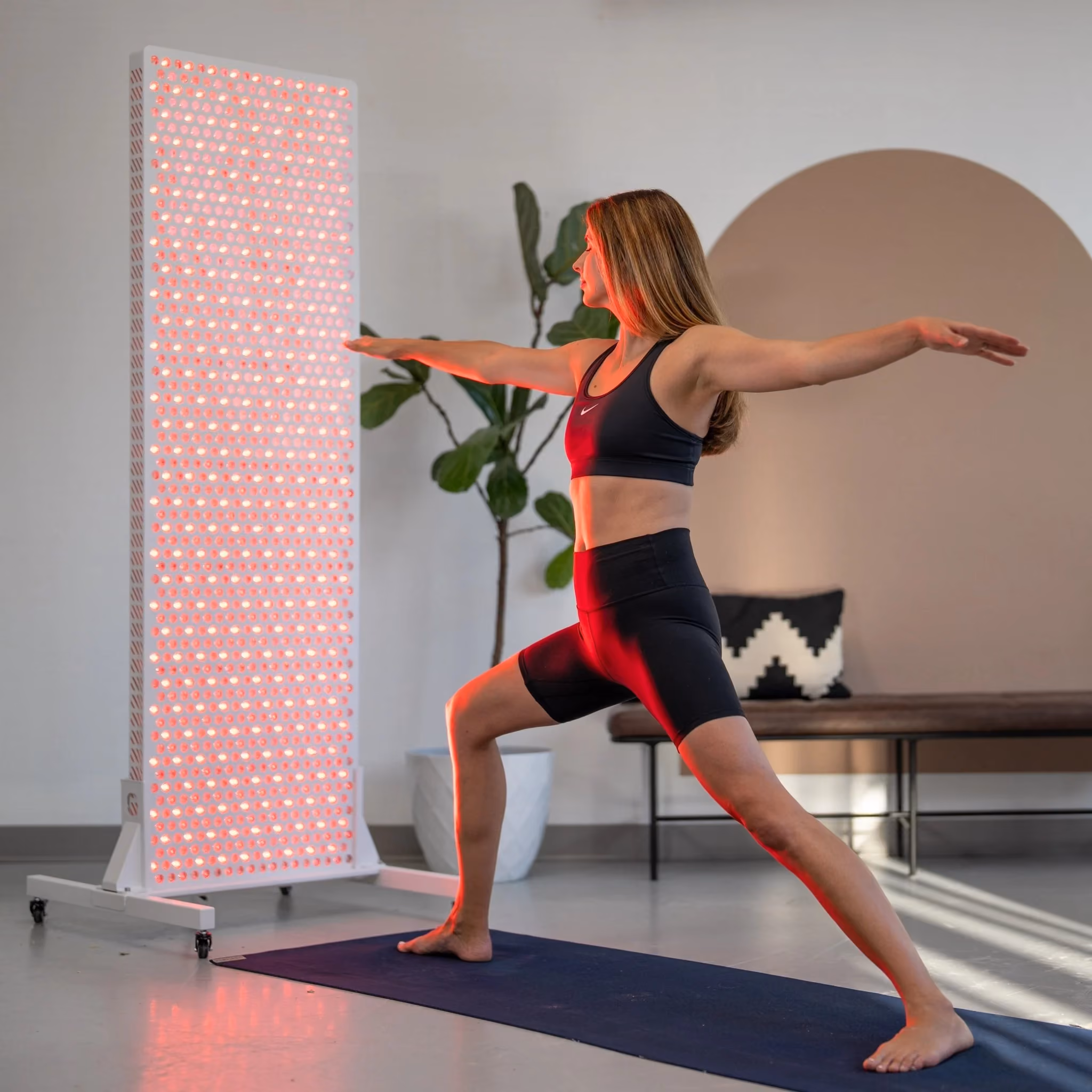 Rouge Ultimate G4 red and near-infrared light panel shown beside a yoga practice